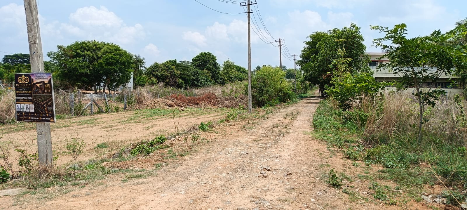 Electricity poles and main road leading to site at Infenity Dwarka Enclave at Hampapura, Bidadi